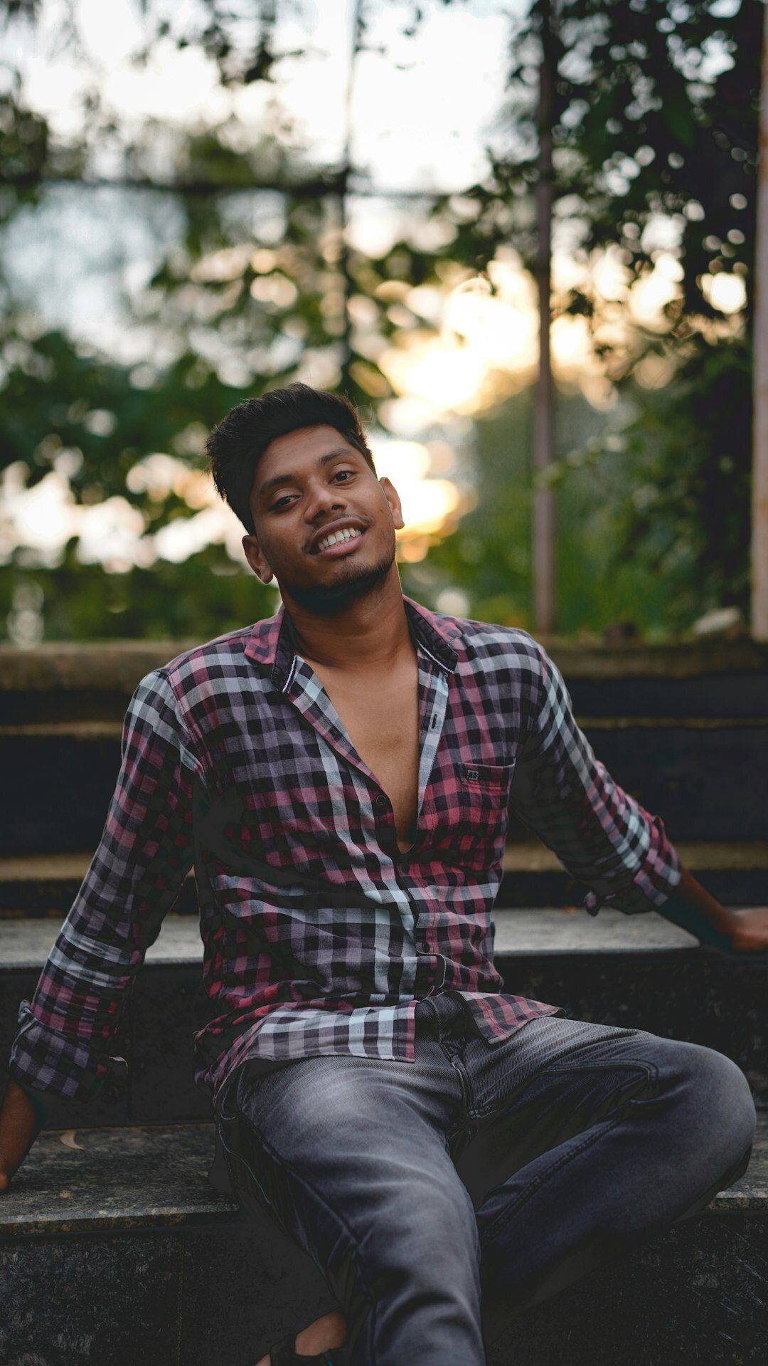 Studio portrait of a Singaporean Chinese man in a smart casual shirt smiling at the camera