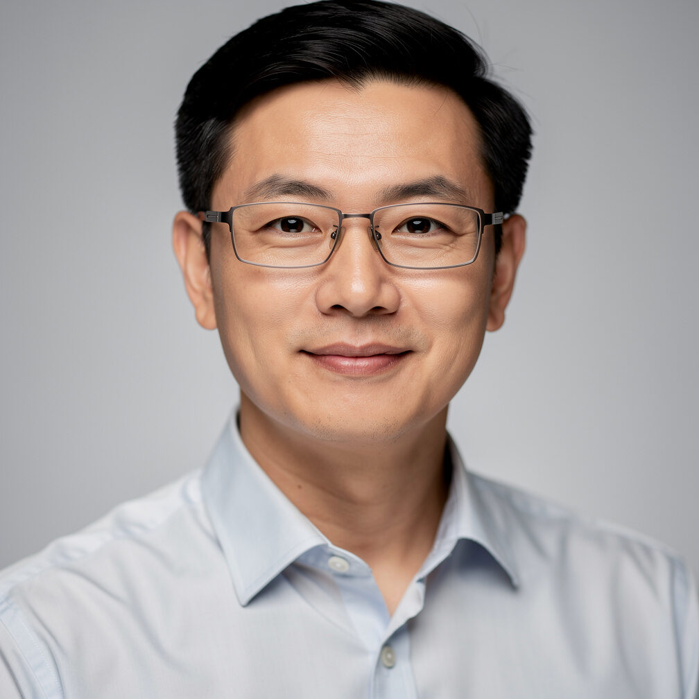 Headshot of a Chinese male solutions architect wearing glasses